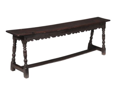  A Charles I oak long stool or bench  , circa 1630, the rectangular seat with moulded edge above a frieze with decorative sha