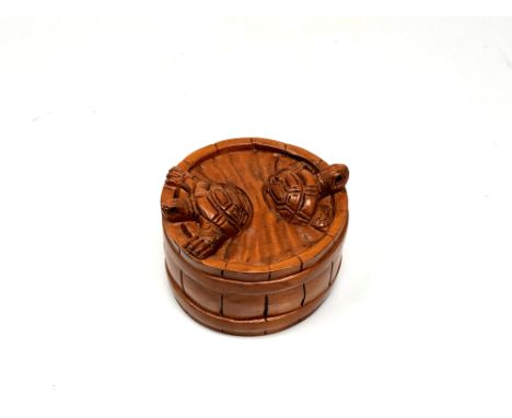 A carved Chinese hardwood netsuke - Two turtles in a barrel