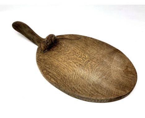 A Robert 'Mouseman' Thompson of Kilburn oak cheese board, with carved mouse signature, length 37cm