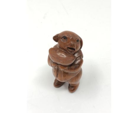 A carved Chinese hardwood netsuke - Pig