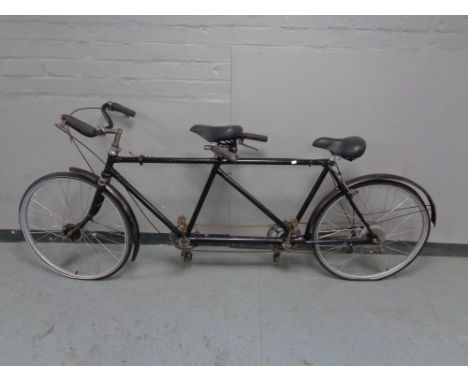 A vintage tandem bicycle with sprung seats 