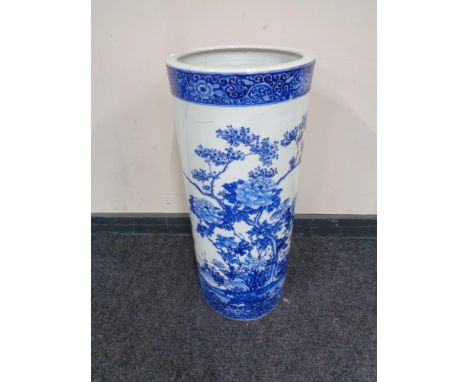 A blue and white porcelain stick pot in oriental design, height 62cm