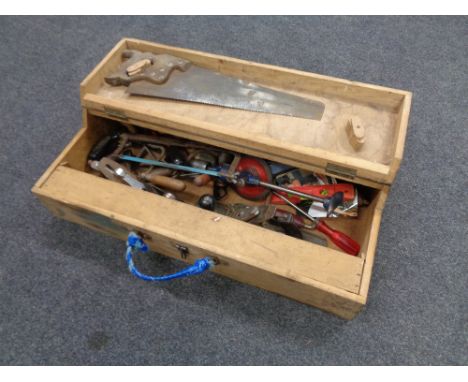 A mid 20th century joiner's toolbox containing assorted tools to include hand saws, Stanley woodworking planes, egg whisk dri