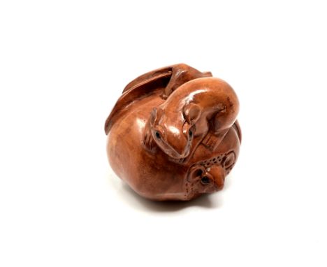 A carved Chinese hardwood netsuke - Two rats on fruit 