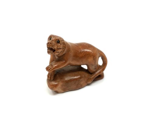 A carved Chinese hardwood netsuke - Tiger