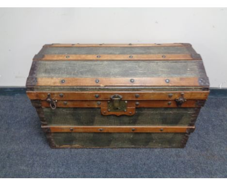 An early 20th century bound domed topped shipping trunk 