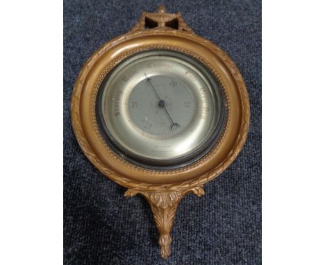 An early 20th century Gomme Furniture of Whickham barometer with silver dial in a gilt frame   
