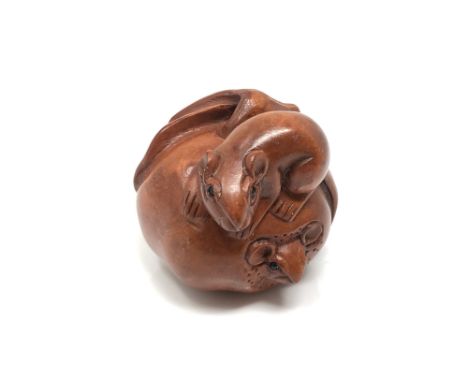 A carved Chinese hardwood netsuke - Two rats on fruit 