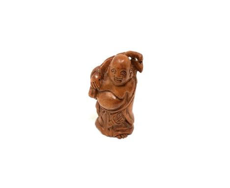A carved Chinese hardwood netsuke - Village elder holding a sack