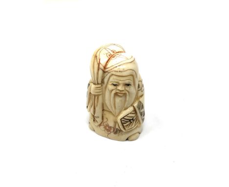A carved Chinese bone netsuke - Village elder holding a sack