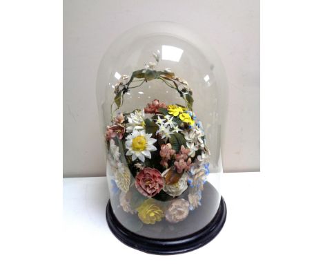 A Victorian glass dome on stand containing ceramic flowers, height 47 cm  
