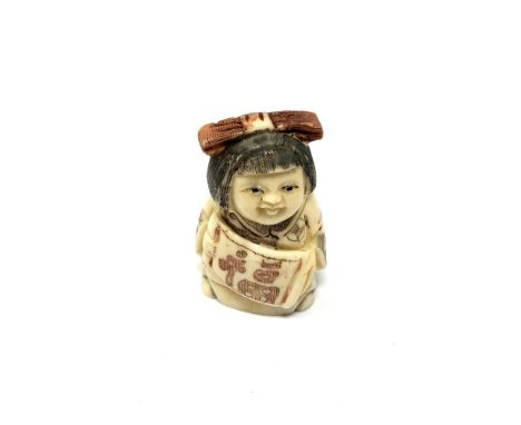 A carved Chinese bone netsuke - Lady with hair bow