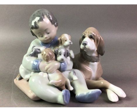 LLADRO FIGURE GROUP AND THREE NAO FIGURES the Lladro group modelled with a boy, dog and puppies, the Nao figures of a girl, a