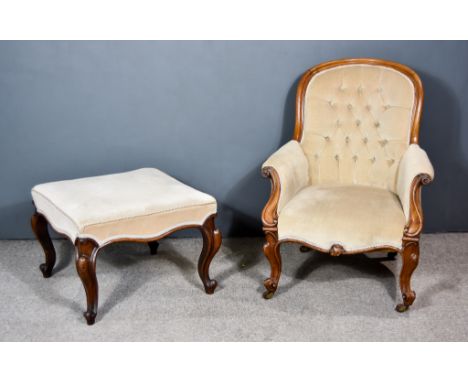 A Victorian Walnut Framed Spoon Back Easy Chair, with moulded frame, scroll carved arm terminals, the back, seat and arms uph