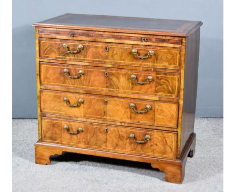 A George III Figured Walnut Chest, with moulded edge and cross banding to top, fitted brushing slide, and four long graduated