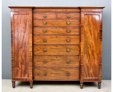 A George IV Figured Mahogany Wardrobe, with moulded and beaded cornice, plain frieze, fitted two short and six long graduated