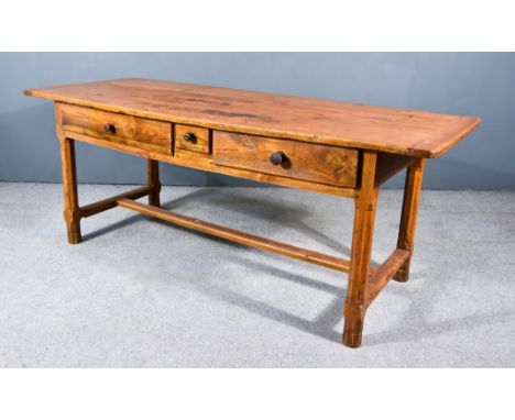 A 19th Century French Provincial Fruitwood Kitchen Table, with two plank cleated top, fitted three frieze drawers to one side