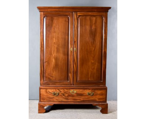 A George III Figured Mahogany Gentleman's Wardrobe, the upper part with moulded cornice, fitted hanging rail enclosed by a pa