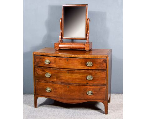A George III Mahogany Bow Front Chest and a Toilet Mirror, the chest with crossbanded top and inlaid with stringings, fitted 