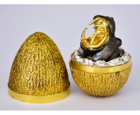 ***An Elizabeth II Silver Gilt "Surprise" Egg by Stuart Devlin, London 1973, limited no.183, the textured shell containing ox