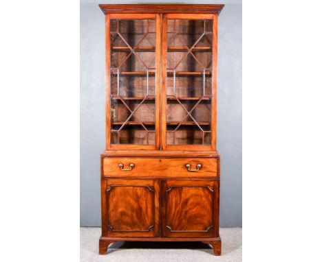 A George III Mahogany Secretaire Bookcase, the upper part with moulded cornice, fitted four shelves enclosed by a pair of ast