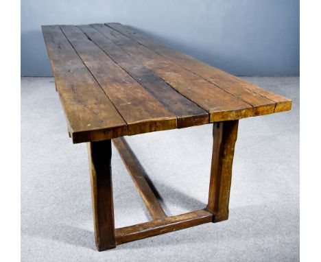 An Oak Refectory Table of 17th Century Design, with five plank top, plain frieze, and on plain stretchers and chamfered suppo