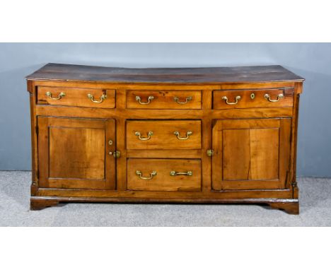 A Late 18th Century Fruitwood Dresser Base, with moulded edge to top, fitted five small drawers and two cupboards, each enclo
