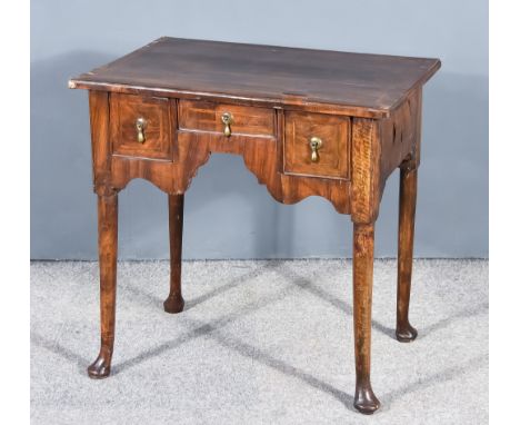 An 18th Century Walnut Lowboy, with cross banded edge and feathering to top, fitted three small drawers, on turned supports w