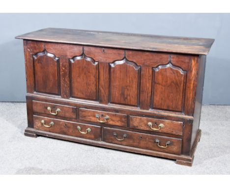 An 18th Century Oak Mule Chest, the front with four shaped and fielded panels, fitted three small and two long drawers under,