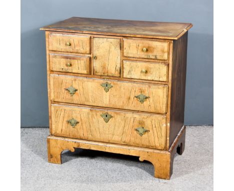 An Old Walnut Cabinet of 18th Century Design, with quarter veneer and cross banding to top, fitted small central cupboard, fo