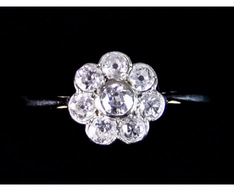 An 18ct Gold Diamond Flower Head Ring, set with eight brilliant cut white diamonds, approximately .75ct total, size S+, total