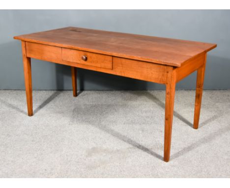 A 19th Century French Provincial Fruit Wood Kitchen Table, with three plank cleated top, fitted one frieze drawer, on square 