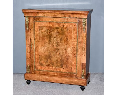 A Victorian Figured Walnut and Gilt Metal Mounted Pier Cabinet, with moulded edge to top, fitted two shelves enclosed by a si