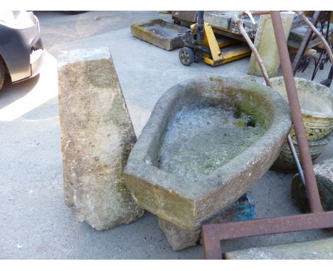A HORSESHOE FORM STONE TROUGH, ANOTHER TROUGH AND A STADDLE STONE WITH TOP.