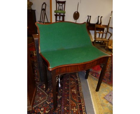 AN 18th.C.MAHOGANY FOLD OVER CARD TABLE OF SERPENTINE OUTLINE ON FLUTED SQUARE SECTION LEGS.   W.86 x H.73cms.