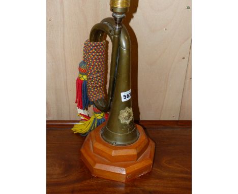 A VINTAGE REGIMENTAL BUGLE LATER MOUNTED AS A LAMP.