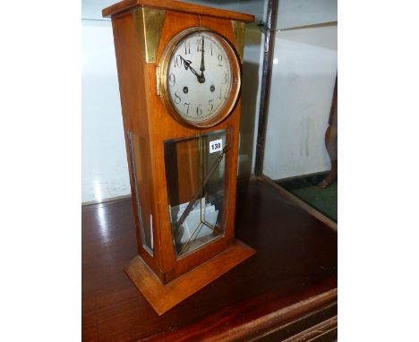 AN EARLY 20th.C.GERMAN MANTLE CLOCK IN ARTS AND CRAFTS STYLE, THE WALNUT CASE WITH GLAZED PANELS AND SILVERED ROUND DIAL.