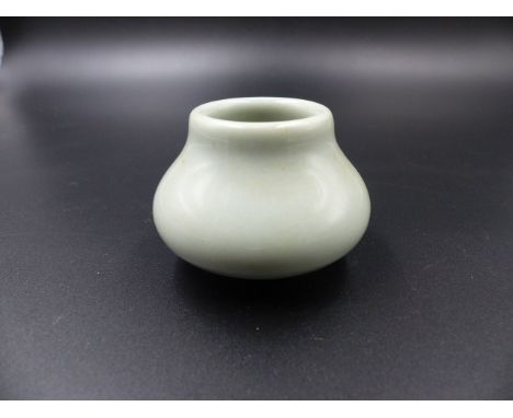 A CHINESE PALE CELADON SQUAT FORM MINIATURE VASE WITH SEAL MARK TO BASE.   H.4.5cms.