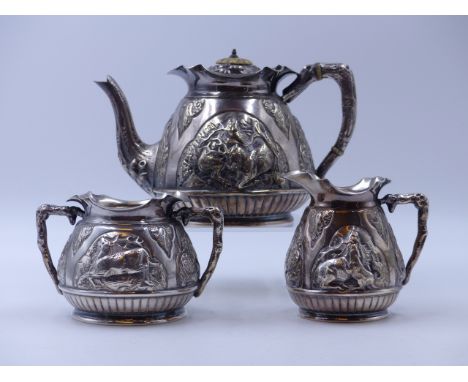 A VICTORIAN SILVER HALLMARKED THREE PIECE TEA SET, DATED 1893 LONDON, FOR CHARLES EDWARDS, WITH A REPOSSE HUNTING SCENE. GROS