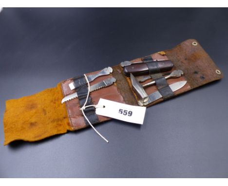 A BONZA TYPE LEATHER CASED TOOL KIT CONTAINING VARIOUS TOOLS AND IMPLEMENTS.