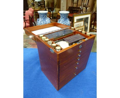 A MID 20th.C.MAHOGANY CASED DENTIST CABINET WITH RISING LID AND SIX GRADUATED DRAWERS ALL FULLY FITTED WITH DENTAL TOOLS,ETC.