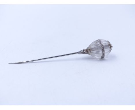 A CRYSTAL AND DIAMOND SET FLUTED ORB STICK PIN. MEASUREMENTS 7.5cms.  