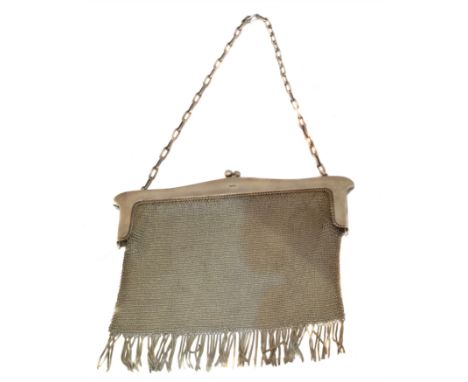 A George VI silver mesh purse, of tapered rectangular form, the mesh bag with fringed base and sinuous push piece clasp, susp