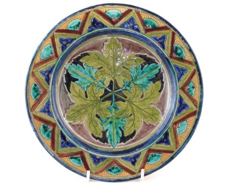 Della Robbia small charger, painted by Tom Hall over an incised leaf pattern, 26.5cm diameter CONDITION REPORT: Small chips t