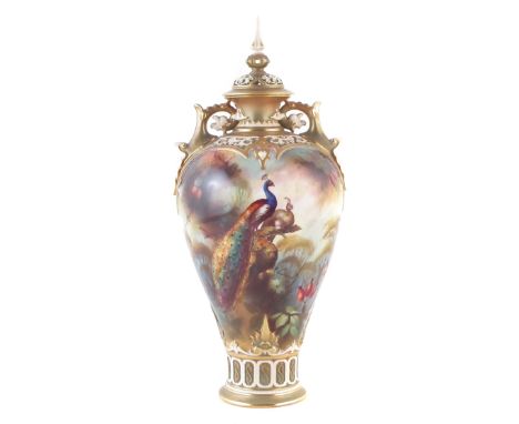 Royal Worcester twin handled lidded vase signed W.E. Jarman, painted with peacocks within forestry scenes, shape F100 date co