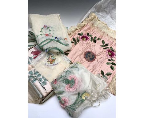 Embroidered items including a sheer embroidered apron, scarf, and embroidered wall hangings.