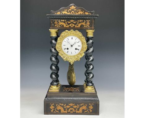 A mid 19th century French portico mantel clock, contained in an ebonised and boxwood inlaid case, with brass capped barley tw