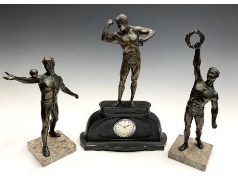 An Art Deco period spelter and marble three piece figural clock garniture, the figures modelled as athletes. Height 36.5cm di