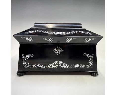 A Regency coromandel tea caddy with mother of pearl inlay, of sarcophagus form, the two lidded sections flanking a glass mixi