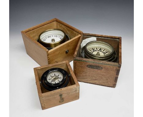 A gimbal compass, in an oak case with glazed top, labelled for Philip Tacey Ltd, width 15.5cm, together with another, the Dir